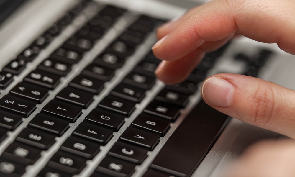 Hand Over MacBook Keyboard